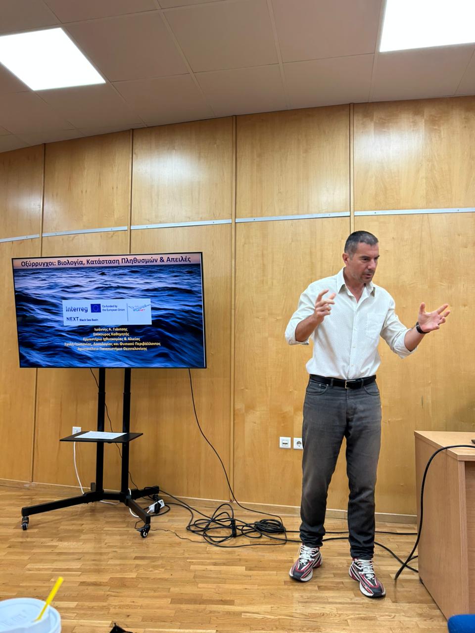 Speaker presenting sturgeon biology and conservation topics